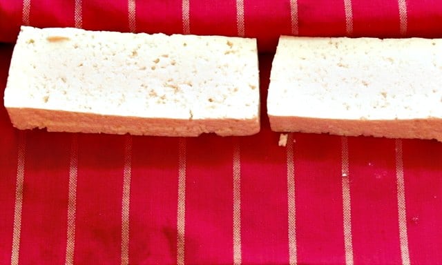 Slabs of tofu on a towel, to remove water.