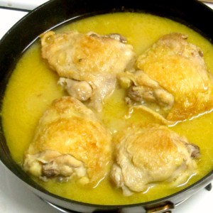 Chicken thighs braised in orange juice with a touch of ginger to add depth - easy and delicious! www.inhabitedkitchen.com