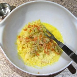 eggs, mirepoix, and crumbled corn muffin in bowl