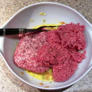 Add sausage meat and ground meat to egg mixture.