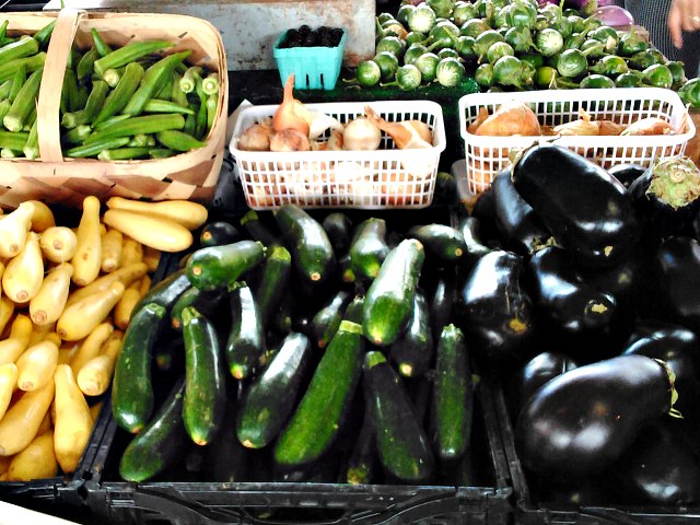 Farmer's market display of zucchini and eggplant