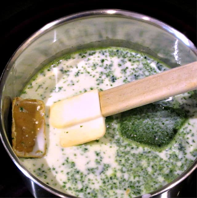 Cubes of spinach and roux in a pot of milk