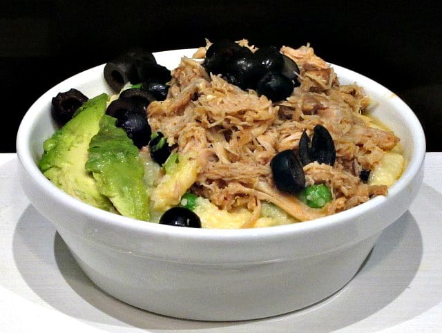 Chipotle Shredded Chicken in a bowl as part of a meal, with garnish